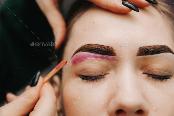 eyebrow waxing. removal of excess hair from the eyebrows