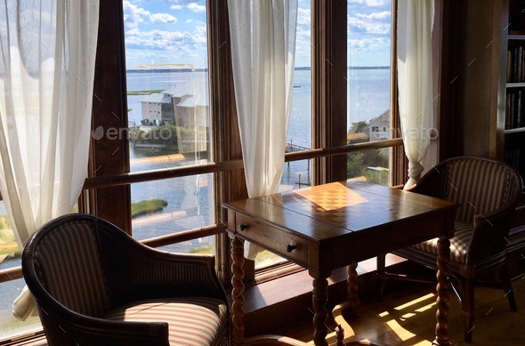 Sitting area at the window, room with ocean view, vintage armchair, living spaces, comfort
