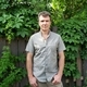 Man in plain shirt outdoor with greenery in background  - PhotoDune Item for Sale