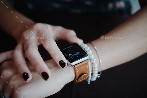 Woman using Apple iwatch smart watch  - Stock Photo - Images