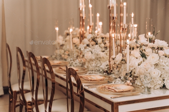 Elegant event set up with floral arrangements and candlelight tablescapes