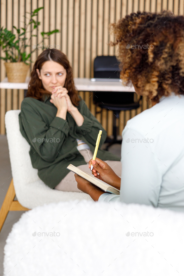 African American female psychologist conducts an appointment with a patient in the office. mental