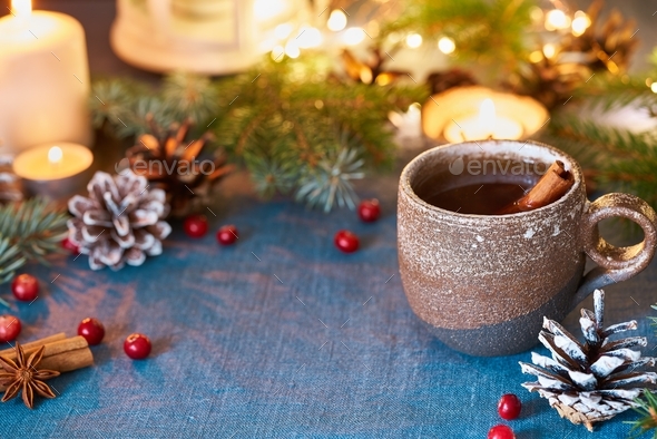 Cup of hot drink on christmas background. Cozy evening, mug of mulled wine