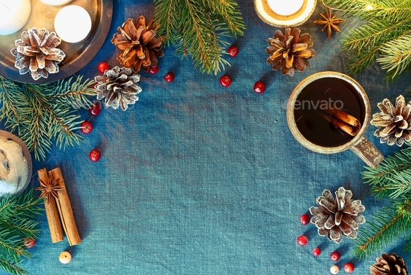 Cup of hot drink on christmas background. Cozy evening, mug of mulled wine, xmas decorations