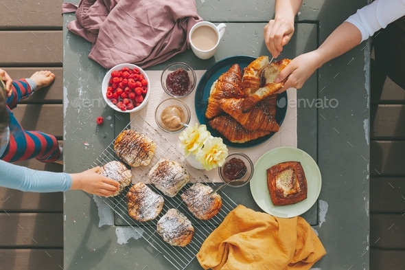 A brunch spread being enjoyed by two people.  - Stock Photo - Images