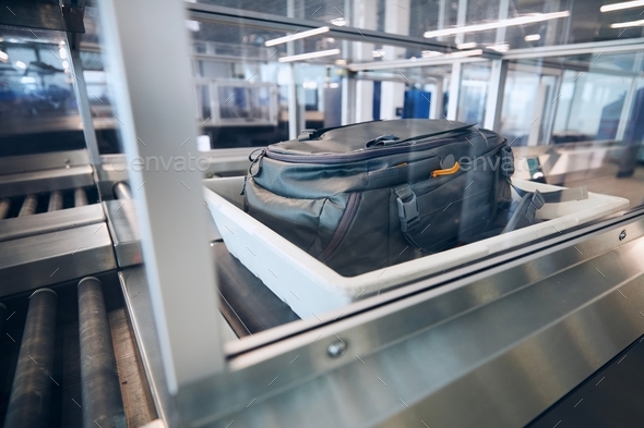 Baggage on conveyor belt during airport security check before flight