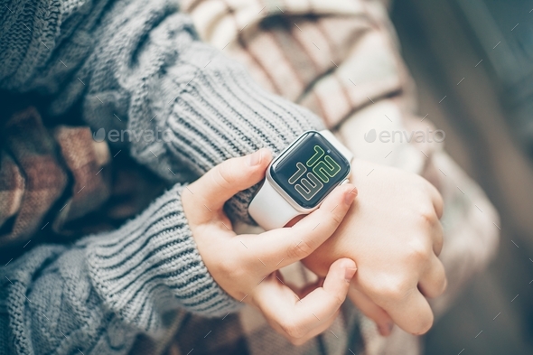 Female hands using Apple Watch  - Stock Photo - Images