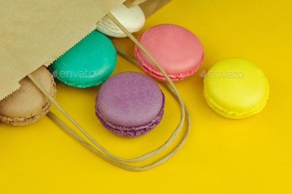 French pastries macaroon on a colored background,