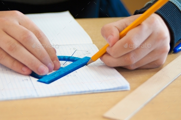  the student draws in a notebook in a cage with a pencil