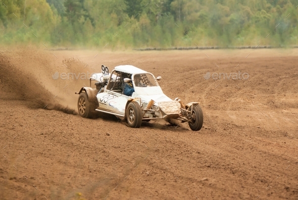 racing car rides at high speed on a sandy road, under the wheels of flying sand - Stock Photo - Images