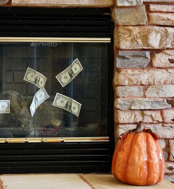 Cash money in a fireplace illustrating wasted money
