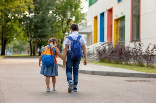 two schoolchildren, a little girl and a boy in a with backpacks Stock ...