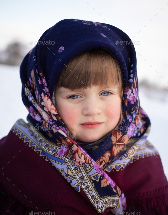 Russian beautiful girl in a purple traditional headscarf on a winter