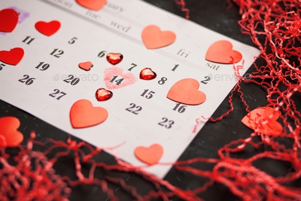 Flat lay layout for holiday for Valentine\'s Day with date of 14 February in calendar, copy space.