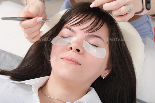woman client lying in beauty salon redy to eyelash extension procedure.  - Stock Photo - Images