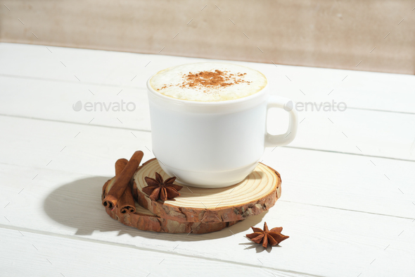 spicy latte coffee with cinnamon and anise in white mug with spice decor. - Stock Photo - Images