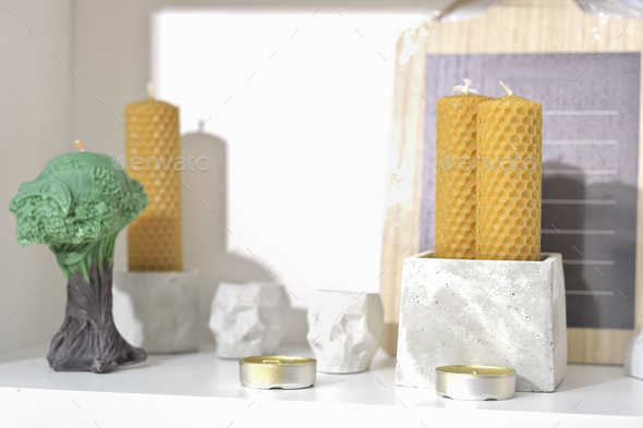 modern trendy loft house decor, beeswax candles, concrete boxes and vases. - Stock Photo - Images