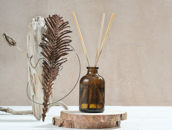 reed aroma diffuser on wooden podium with creative natural composition.  - Stock Photo - Images