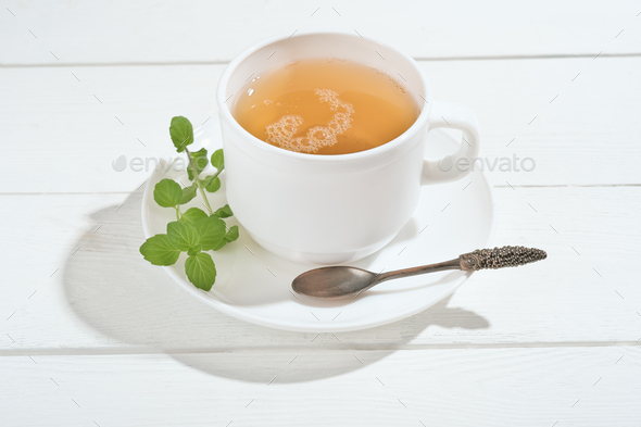 herbal tea with mint on a white wooden table. alternative medicine for gastrointestinal system  - Stock Photo - Images