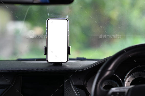 Smart phone with blank screen in car windshield holder.