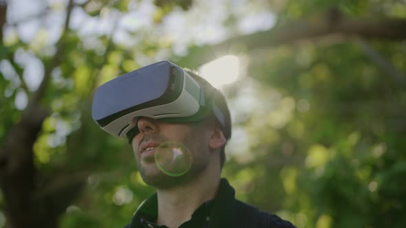 Smiling Man Using Virtual Reality Headset Outdoor alt