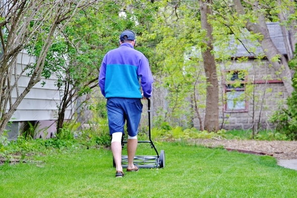Man use reel push lawnmower environmentally friendly
