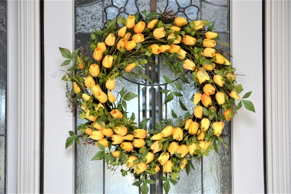 Front door with yellow tulip wreath  - Stock Photo - Images