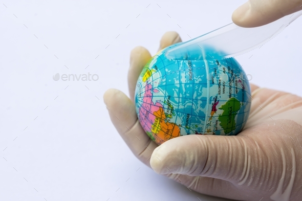 White gloved hand holds a blue globe and a clear plastic knife person hand is holding the knife.