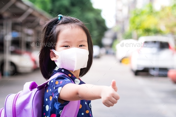 Student girl wearing 3D medical face mask and giving thumb up with school reopening.