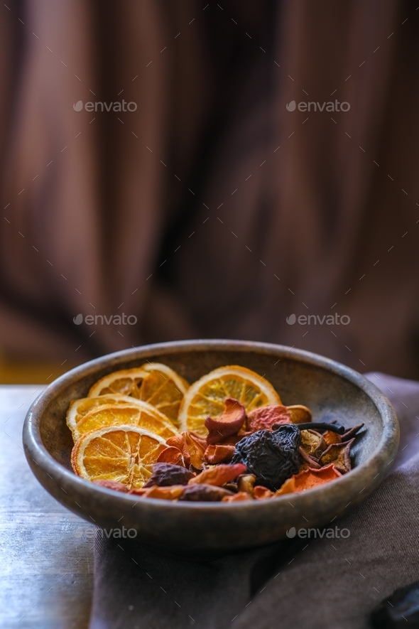 Dried fruits in an old clay plate on a wooden table. Compote. Uzvar