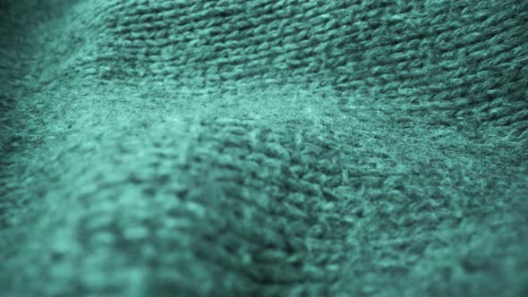 Extreme detail view of sheep wool cloth texture flowing in macro dolly shot. alt