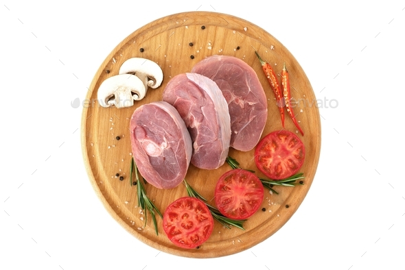 pieces of raw turkey meat, chopped leg steak, portioned barbecue pieces, on white background tomato