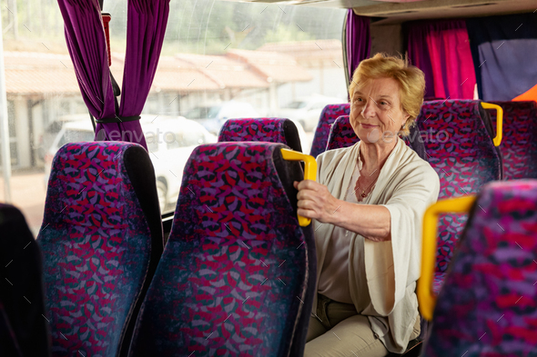 Senior Woman sitting on travel Bus and waiting for excursion