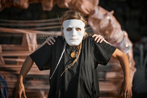 Two girls acting in white theater mask, outdoor art theatrical performance, art festival