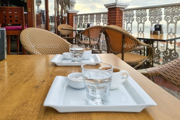 Traditional Turkish cup of coffee and glass of water. Travel Turkey. Coffee break in outdoor cafe