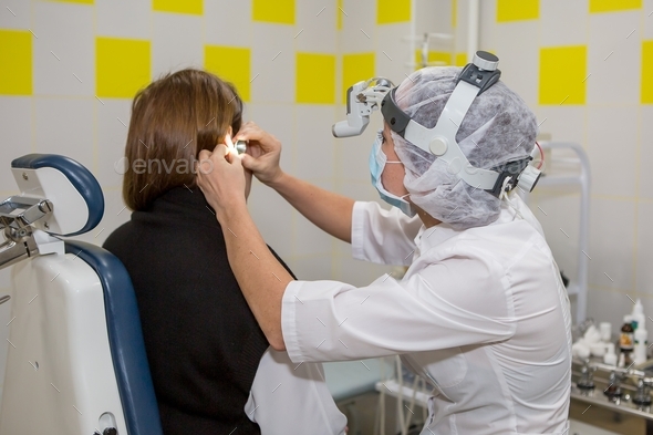Doctor doing ear examination of patient