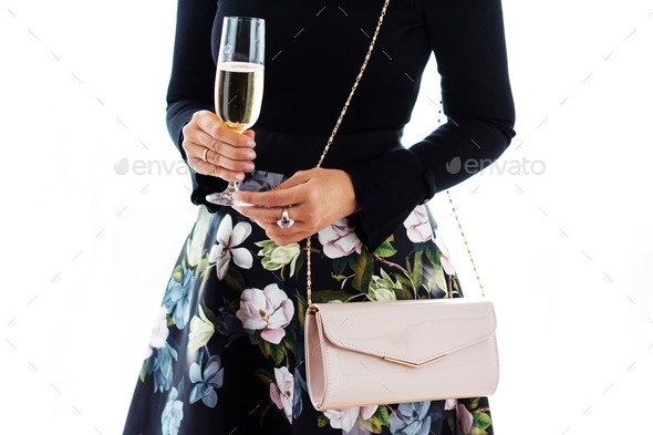 Woman wearing a beautiful and elegant dress, holding a champagne glass, luxury style, well dressed