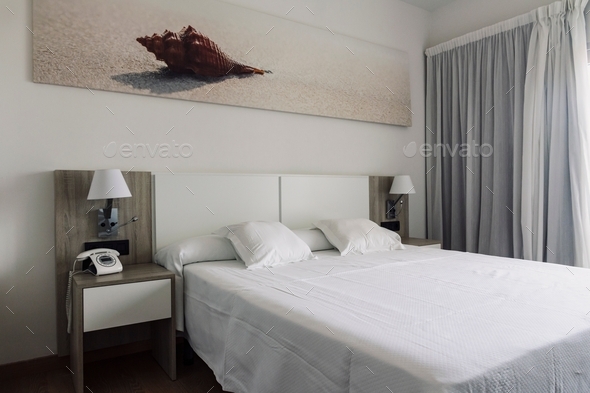 Modern bedroom in a boutique hotel, modern interior design, bed and furniture