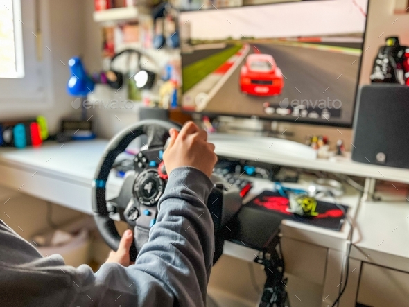 Little Boy Playing Car Game On Computer At Home Stock Photo