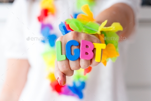 Woman with word lgbt on her hand, colorful letters, rainbow, celebration, gender diversity