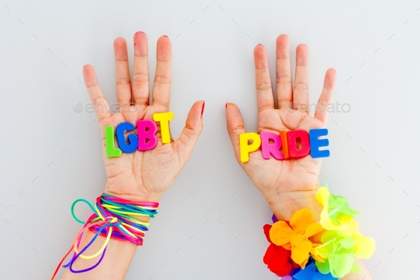 Woman with words lgbt pride on her hands, colorful letters, rainbow, celebration, gender diversity