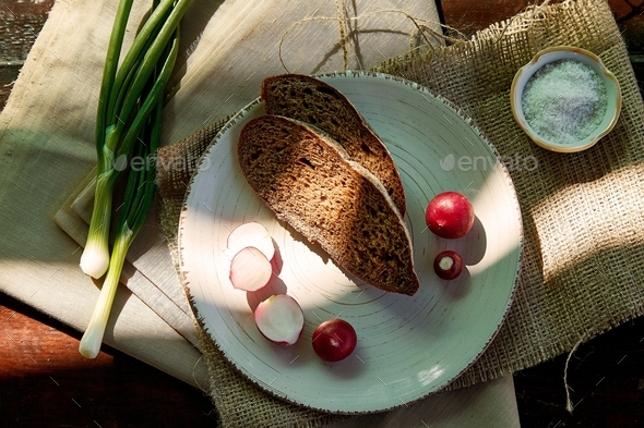 Sourdough bread with radish, salt and young onio. Eat out. Rustic food, snack in countryside
