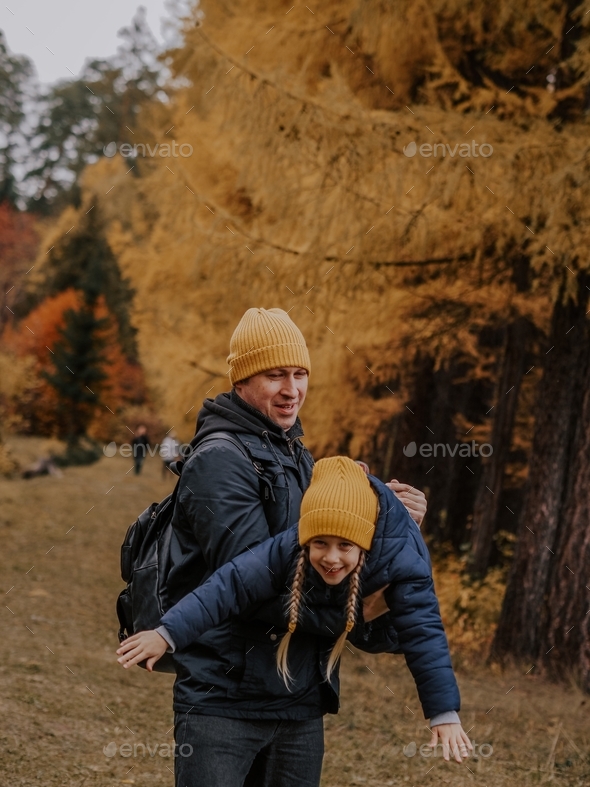 Daddy daughter. Dad and daughter walk in the forest in the fall