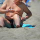 mature man tanning on a sandy beach - PhotoDune Item for Sale