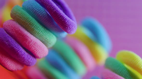 Rubber Bands Close Up Vivid Rotating on the Violet Background alt