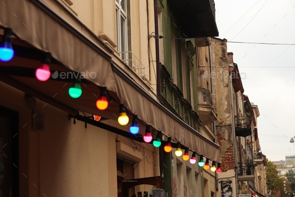 Colorful light bulbs. Classic architecture details. Old facade with light bulb. Decorative external