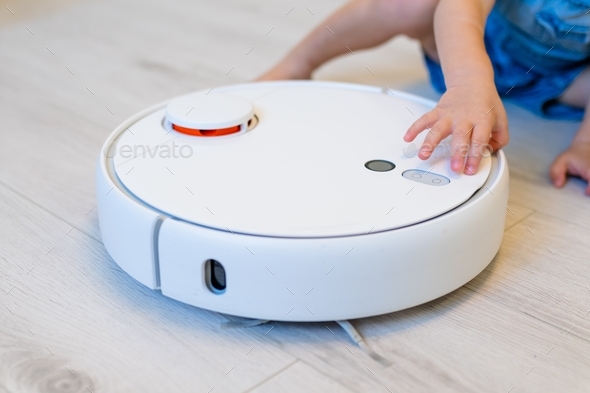 child try open a robot vacuum cleaner