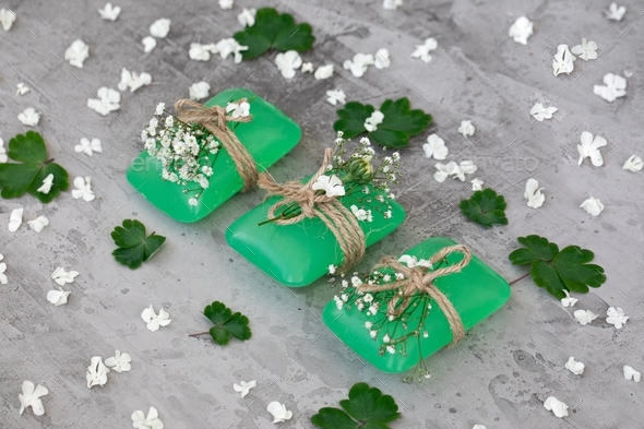 three bars of green soap are beautifully decorated with fresh flowers. Skin care. Bio product.