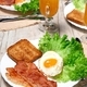 Breakfast: fried egg, lettuce, toasted bread, fried bacon and orange juice. - PhotoDune Item for Sale
