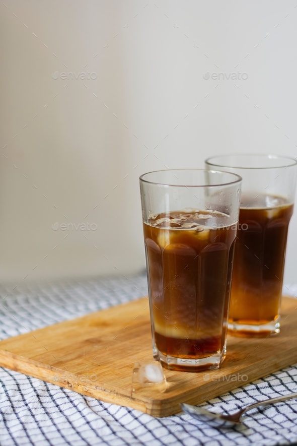 Ready drink cold coffee Bumble in a tall highball glass on a wooden board
